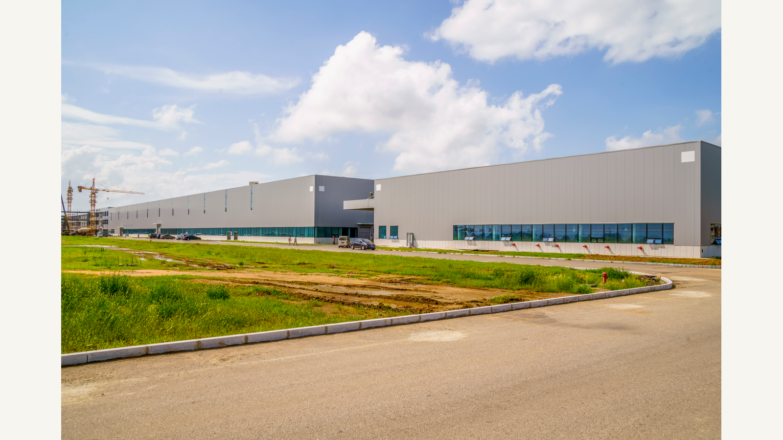Illustration of an industrial park with a factory building and warehouse.