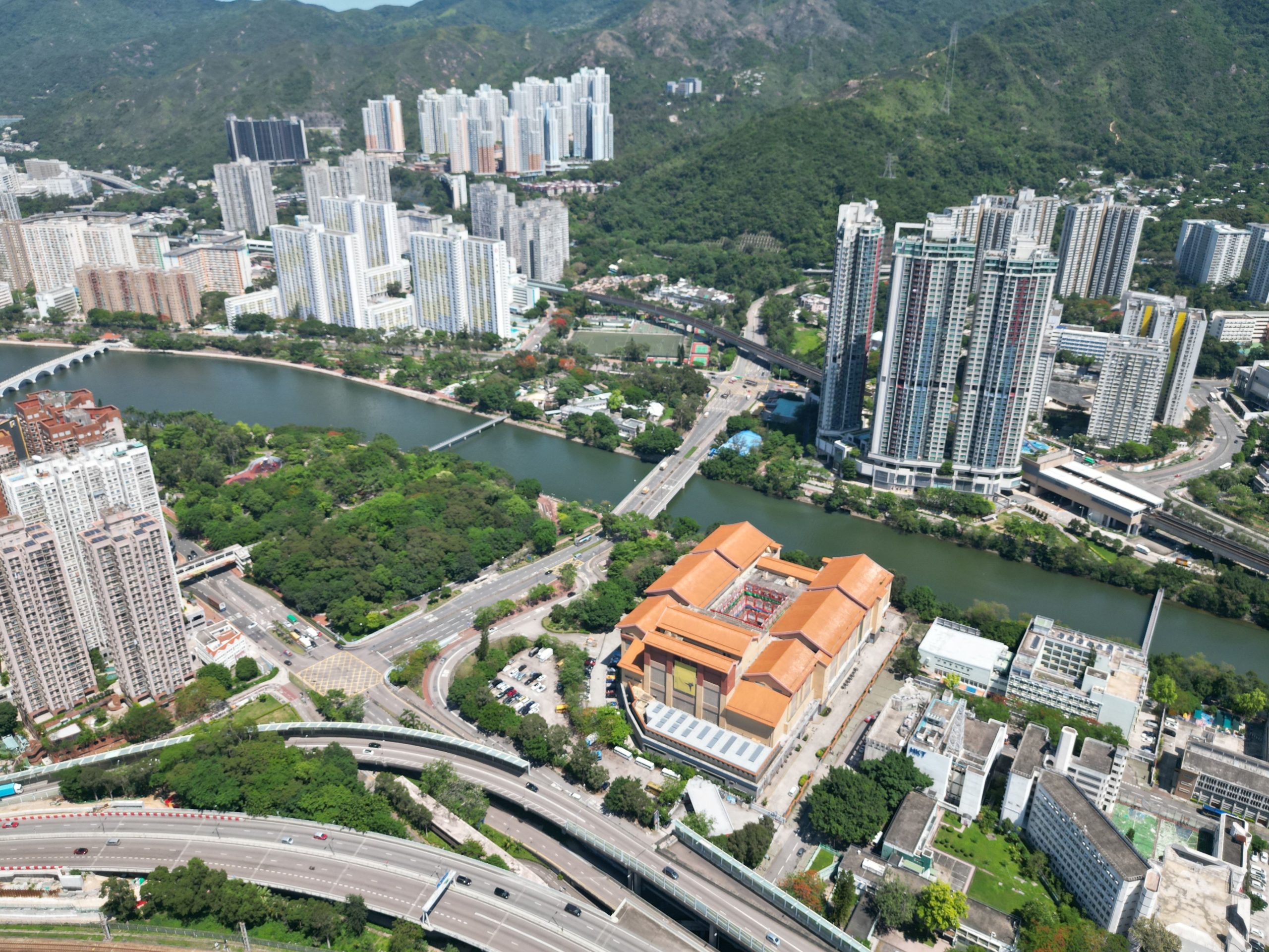 Aerial view of Tai Po New Town in Hong Kong, with tower blocks, a river and elevated roads